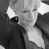 Black and white photo of a woman wearing a star-shaped necklace.